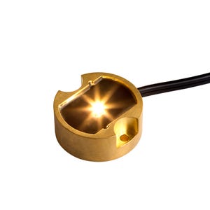 VOLT® BuddyPro brass LED puck light 2700K illuminated with lead wire.